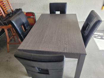 Grey dinning room table and 4 black chairs